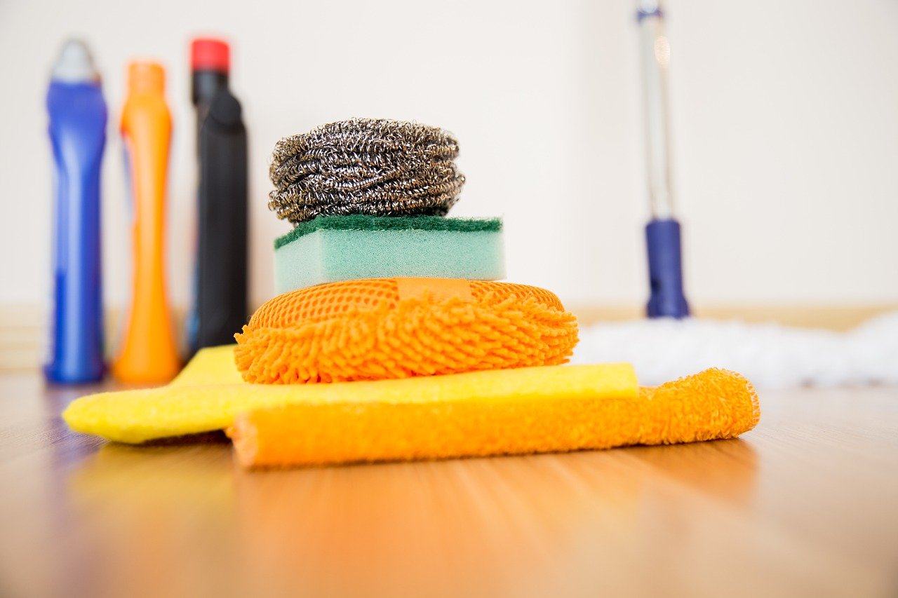 Cleaning supplies in a pile on the floor.