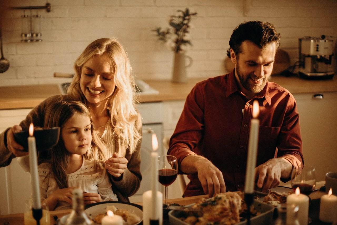 family having meal at the table after residential house cleaning